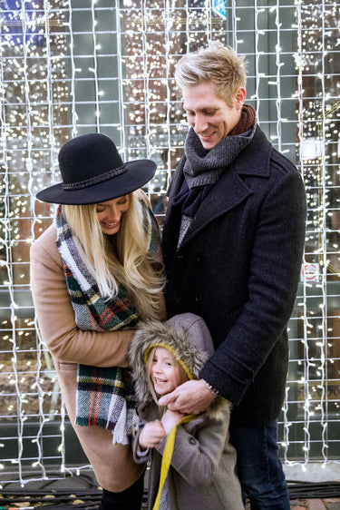 family-laughing-with-holiday-lights