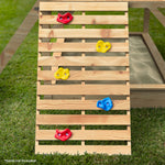 wooden cubby house with slide Australia slatted climbing ramp with colorful climbing holds beside sandbox on grass
